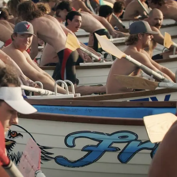 Off-duty lifeguards in ocean racing rowing boats.